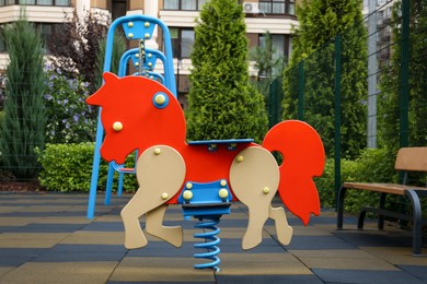 Photo of Empty horse spring rider on children's playground in residential area
