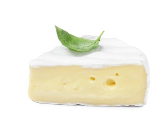 Piece of tasty brie cheese with basil isolated on white