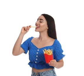 Beautiful young woman eating French fries on white background