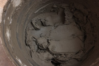 Closeup view of bucket with adhesive mix