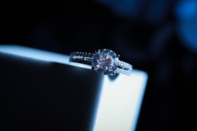 Photo of Elegant jewelry. Stylish presentation of luxury ring on podium, closeup