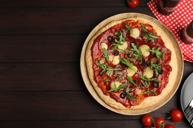 Photo of Pita pizza with cheese, olives, mushrooms and arugula on wooden table, flat lay. Space for text