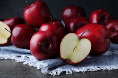 Fresh ripe red apples on grey table, closeup