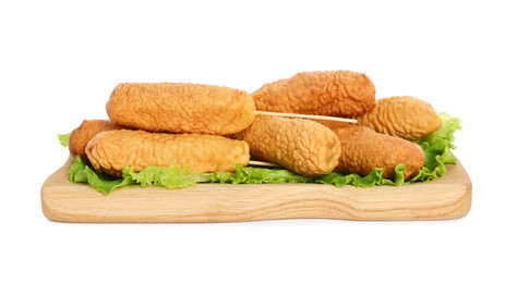 Delicious deep fried corn dogs with lettuce on white background