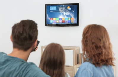 Family watching smart TV in living room