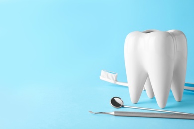 Tooth shaped holder and dentist tools on color background. Space for text
