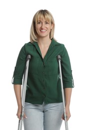 Portrait of happy woman with crutches on white background