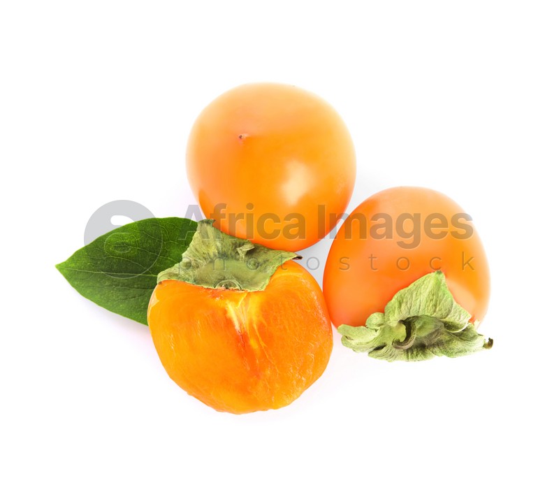 Delicious cut and whole persimmons isolated on white, top view