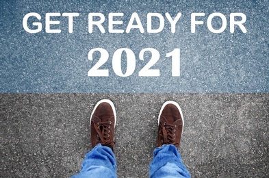 Text Get Ready For 2021 on asphalt in front of man, top view