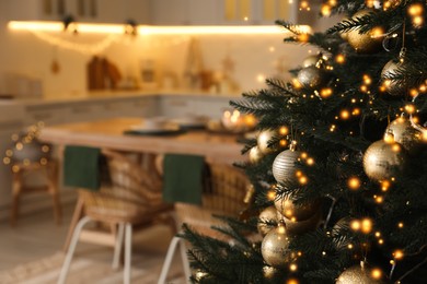 Beautiful Christmas tree in spacious kitchen, closeup. Space for text