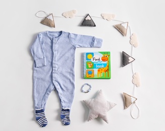 Set of baby clothes and accessories on light background, flat lay
