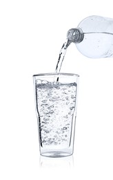 Photo of Pouring soda water from bottle into glass on white background