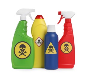 Photo of Bottles of toxic household chemicals with warning signs on white background