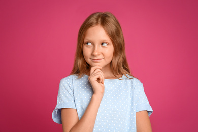 Portrait of preteen girl on pink background