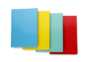 Different colorful hardcover planners on white background, top view