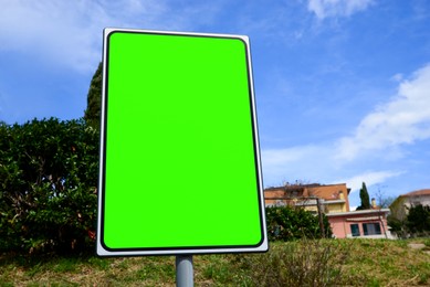 Image of Chroma key compositing. Empty billboard with green screen in city. Mockup for design
