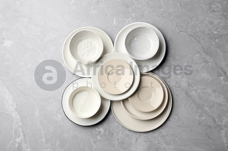 Set of clean tableware on grey table, flat lay