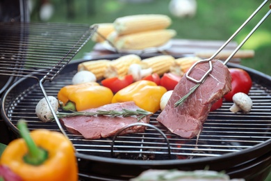 Cooking fresh food on barbecue grill outdoors, closeup