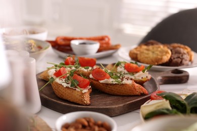 Delicious sandwiches with cheese and tomatoes served on buffet table for brunch