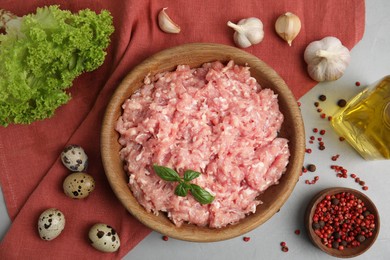 Raw chicken minced meat and ingredients on grey table, flat lay