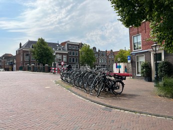 Photo of Beautiful view of parking with bicycles and buildings on city street
