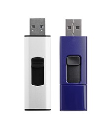 Modern usb flash drives on white background, top view