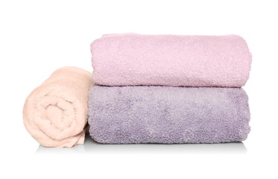 Folded and rolled soft terry towels on white background