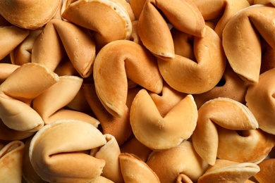 Traditional fortune cookies as background, closeup view