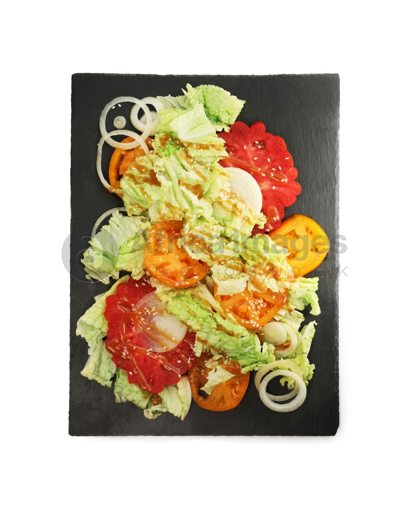 Slate plate of delicious salad with Chinese cabbage, tomatoes and onion on white background, top view