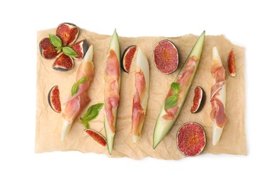 Parchment with tasty melon, jamon and figs isolated on white, top view