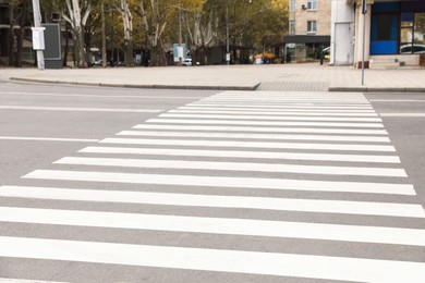 White pedestrian crossing on empty city street
