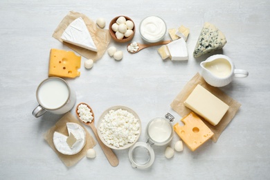 Photo of Frame made with different dairy products on white table, top view. Space for text
