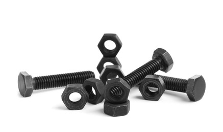 Different black metal bolts and nuts on white background