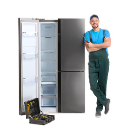 Male technician with tool box near refrigerator on white background