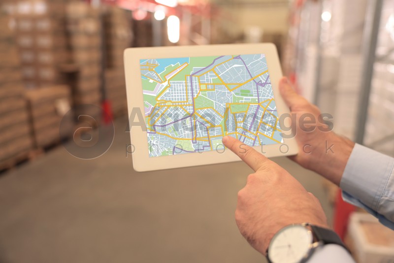Man with tablet at warehouse, closeup. Wholesale business