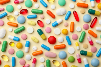 Many different pills on color background, flat lay