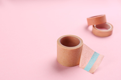Sticking plaster rolls on pink background. Space for text