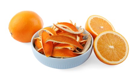 Photo of Bowl with dry orange peels and fresh fruits isolated on white