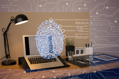 Fingerprint identification. Modern laptop and devices on table indoors