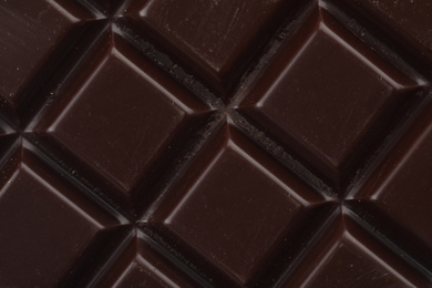 Delicious dark chocolate as background, closeup view