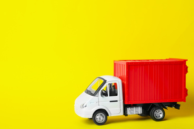 Toy truck on yellow background, space for text. Logistics and wholesale concept