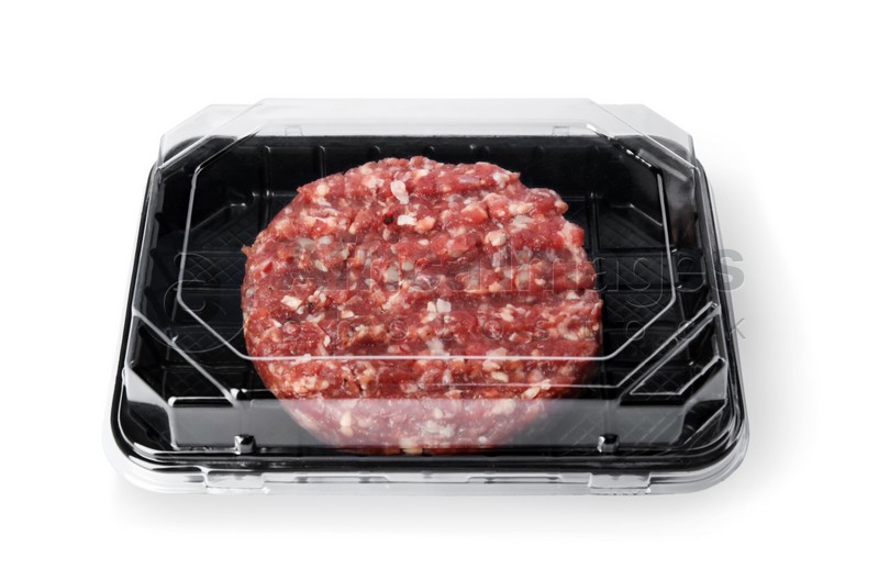Plastic container with raw meat cutlet for burger isolated on white