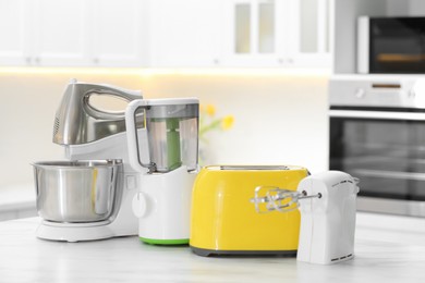 Modern toaster and other cooking appliances on table in kitchen