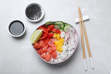 Delicious poke bowl with salmon, rice and vegetables served on light grey table, flat lay