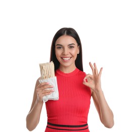 Photo of Happy young woman with delicious shawarma on white background