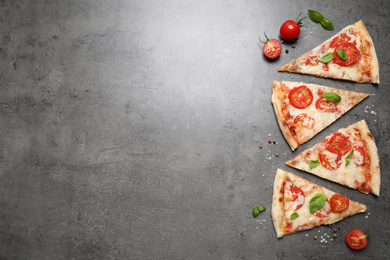 Photo of Slices of delicious pizza Margherita on grey table, flat lay. Space for text