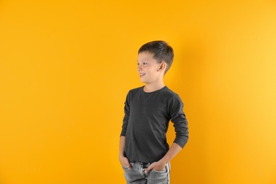 Little boy in long sleeve t-shirt on color background. Mock-up for design