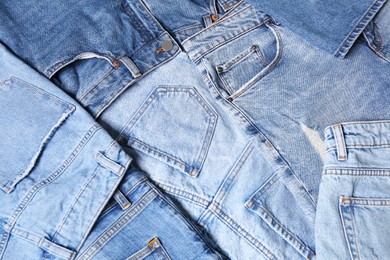 Variety of jeans with different pockets as background, closeup