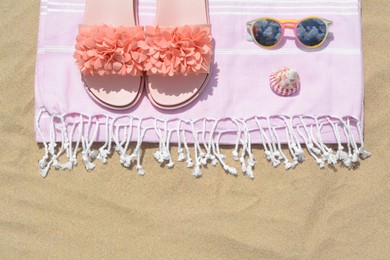 Photo of Stylish beach accessories on sand outdoors, top view. Space for text