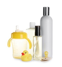 Bottles of baby oil, other cosmetic products and accessories on white background